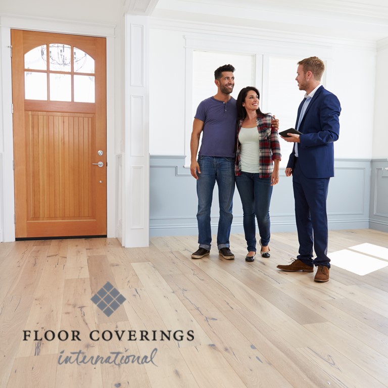 floor coverings international franchise homeowners and man stand in room with hardwood