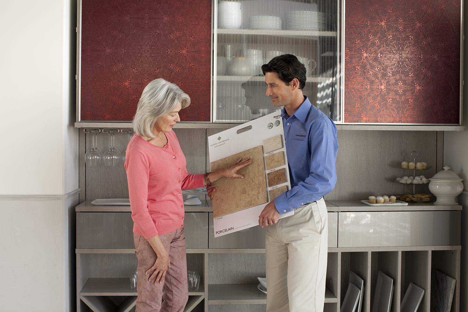 floor coverings international franchise owner shows floor samples to customer